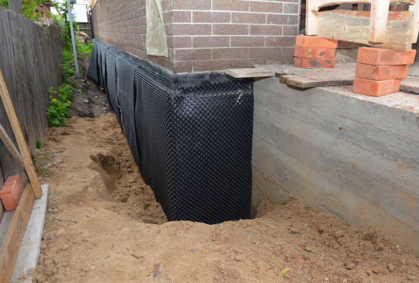SJ Waterproofing Pros technician performing targeted Wet Basement Repair assessment in Wharton, OH